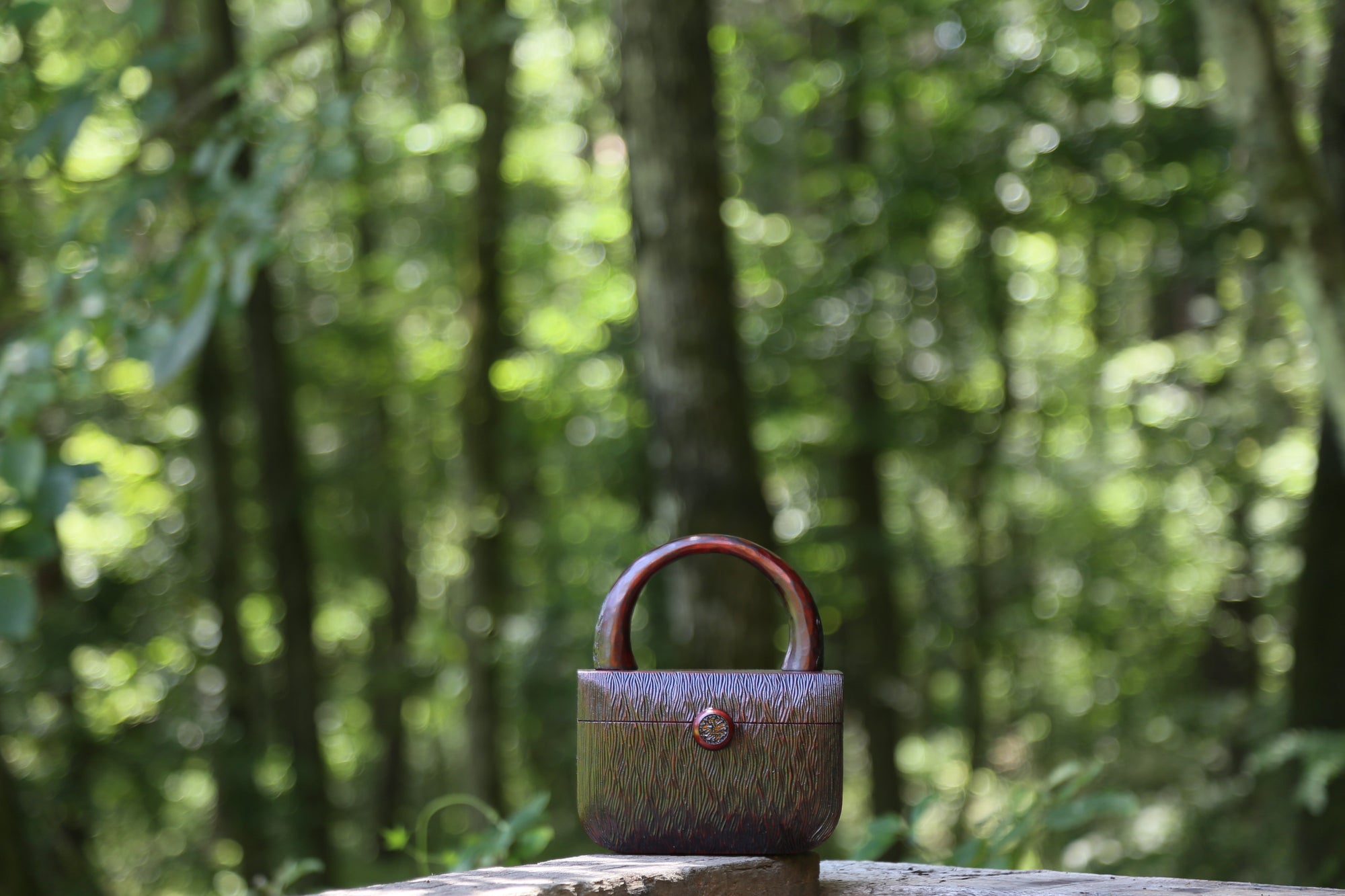 brown kinokaban (wooden bag) is in the forest scene